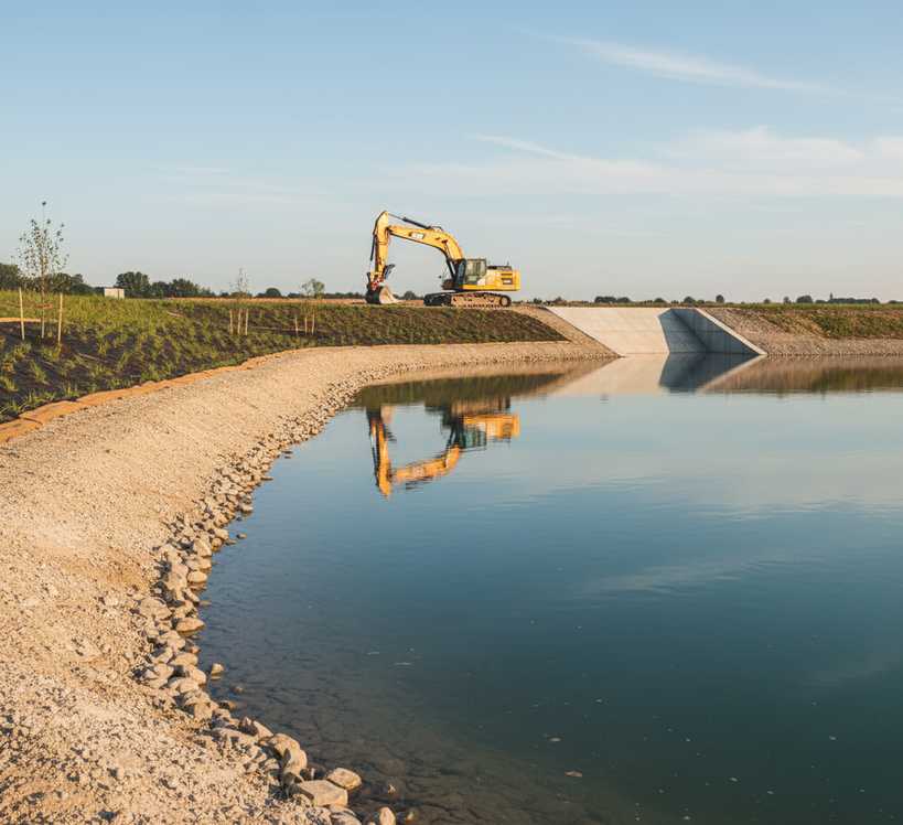 Large earthmoving equipment working on lake excavation